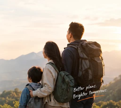 A young family on a mountain ridge at sunrise, looking out over the valley